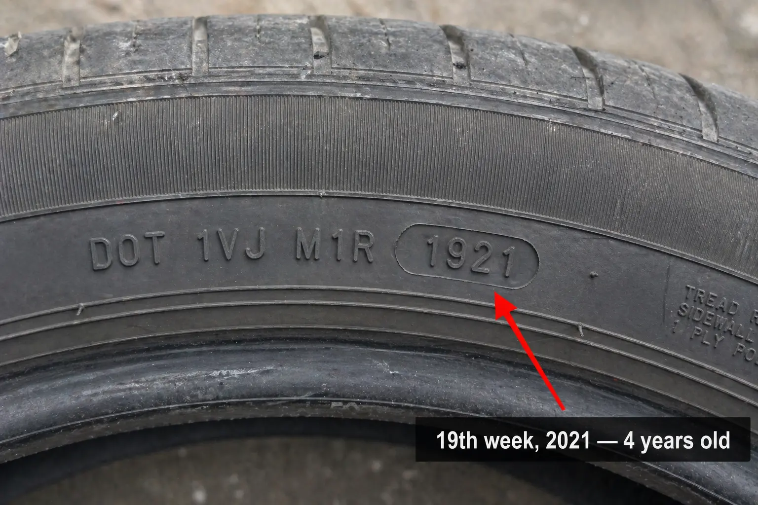 Tyre sidewall showing DOT code 1921 with annotation marking manufacture date — used to verify claimed mileage against tyre age